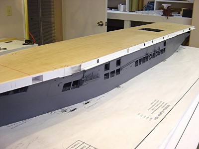 Here's an overall view of the portside of the ship. Note that I have transferred the paper patterns of the sides of the hull to .040 styrene sheet. Sides were then installed on the hull.