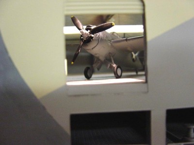 Looking thru the side of the ship, you can see the aircraft parked on the hanger deck.