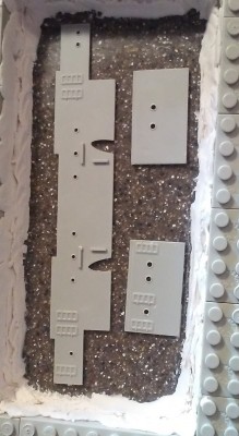 The mold box built with Legos on the Corian base using mineral clay to seal it.