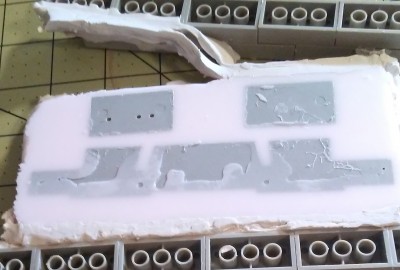 De-molding of the plastic parts once the mold material has cured.