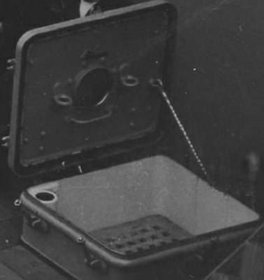 A close up of the square hatch showing the grate and the vent tube in the upper left of the hatch.