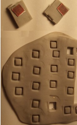 The polymer clay (after hardening) I used an exacto blade to cut them lose (but not popped out) and glued a grate photo to the top. I thin popped them out and cut off the excess of the photo grate.