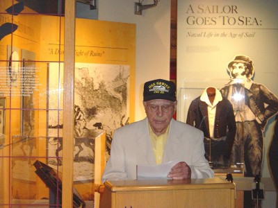 Mr. Charles Howse. He was a gunner in a TBF Avenger, shown here giving a short speech at the dedication ceremonies.