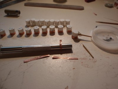 wraped the brass stripes around knife handle to get the bend,brass rod for blast bag support,then white glue