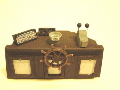 The 'bridge" inside the P/H. Cabinet is balsa. Wheel is a brass casting. The guages and controls are made from aircraft inst. panel photos I reduced in size to fit. Compass is real! Knobs on doors are just sewing pins.