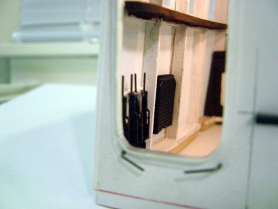Machine gun rack added next to heater.