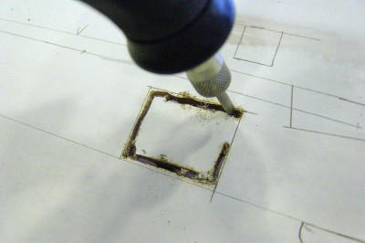 Using a Dremel with a small router bit, I carefully cut out the openings using my lines for a reference.