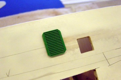 Here is one of the louver openings. The louver itself is a Lego part, works great here. I'll glue this behind the opening. There are eight of these in total, four on each side.