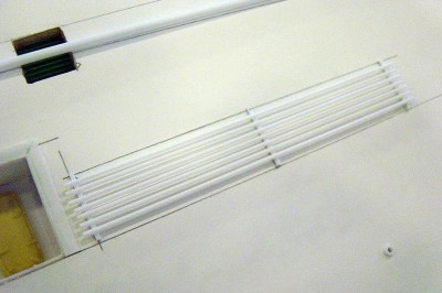 Next, I'll add the refueling hoses above the aft sponson deck and the midships platform. .040 styrene strip and .047 rod used here.