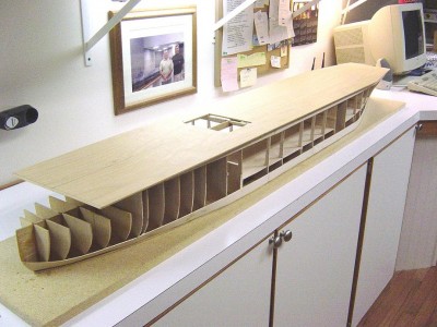 Here you can see the framework is completed and I have rough cut the flightdeck. Main keel and the bottom to the waterline are 3/16 ' marine plywood. Bulkheads are 1/8" hard balsa. Note the aft elevator will be open.