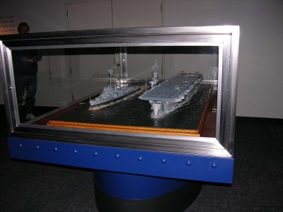 Bow view here. The glass around the case is 3/8" safety glass. The case itself must be heavy. My display is 150 lbs+.