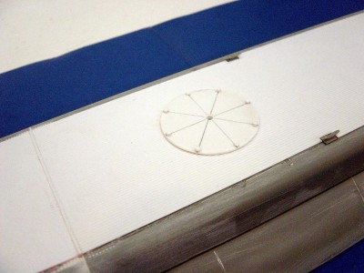 One of the round bolted plates covering the 5" deck gun locations. One fwd and one aft. Made from .030 styrene sheet and hexagon tube.