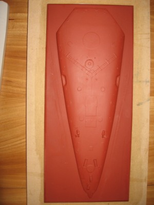 The fore deck plug is here seen complete with detail. The red oxide primer makes a good surface for the silicon mould.