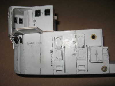 The doors, steps and lockers on the port side of the deck structure.