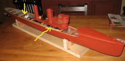 The arrows indicate the eventual limit of the removable deck aperture. The forward limit will be the front of the bridge structure.