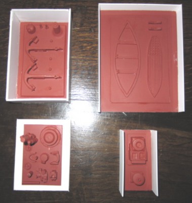 Moulds for casting the parts to make various deck fittings, including guns, anchors, steam capstan and dinghy interior.