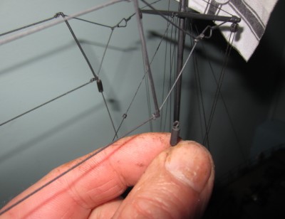 There are two steadying lines with insulators, which run from the deck to the aerial. These have small wire hooks and can be disconnected.