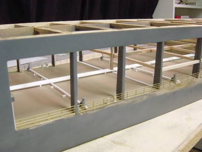 In this photo you can see the overall arrangement a little better. I have added the gate valves on the pipes the go outward to the sides of the hull. Again note the framework for the hanger deck floor, 3/16" balsa stick. Railings are p/e brass, other fittings are cast metal.