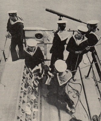 Crew signalling. Note the bare feet. Many crew seemed to have gone without shoes when working on deck. This would not be the case with engineers and stokers.