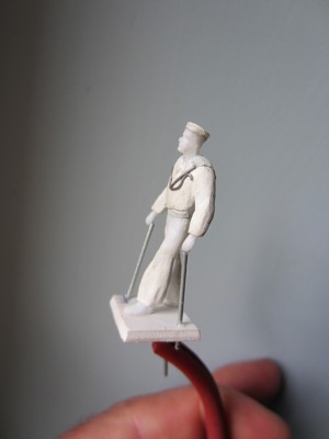 The figure has been mounted on a plastic card base with sloping edges.