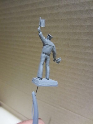 A cast resin figure in grey spray primer.
