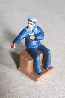 The sailor will be in the aft cockpit of the picket boat model with his arm along the cockpit edge.