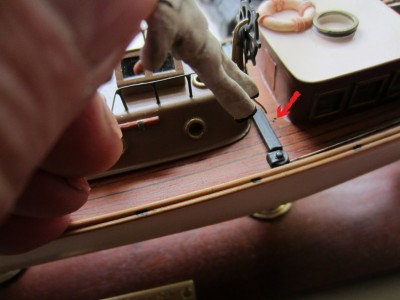 A 0.5mm hole was drilled in the deck and the wire attached to the figure was inserted.